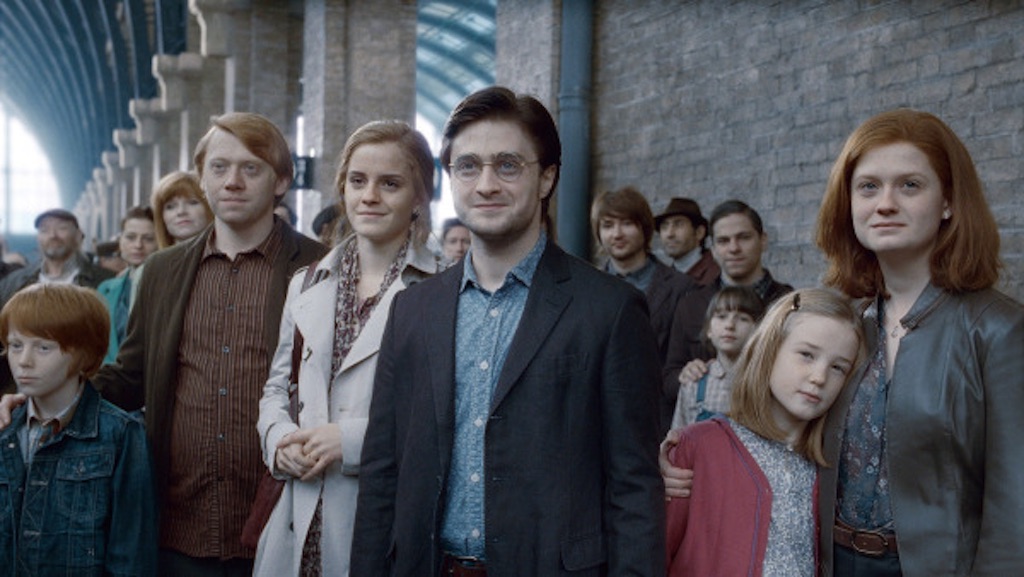 Ron Weasley, Hermione Granger, Harry Potter, and Ginny Weasley on the train station platform at the end of Harry Potter and the Deathly Hallows Part 2