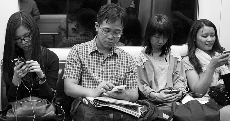 Subway passengers glued to their phones, by theWolf