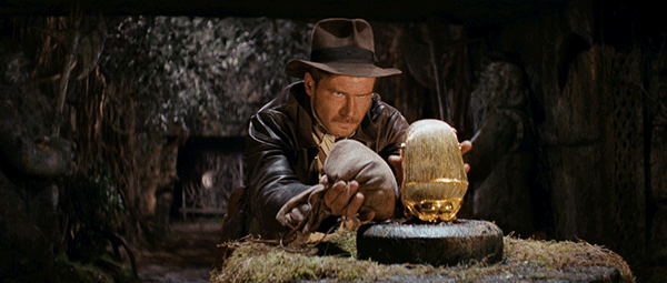 Harrison Ford as Indiana Jones steals the idol in the opening scene of Raiders of the Lost Ark