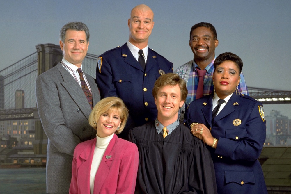 John Larroquette, Markie Post, Richard Moll, Harry Anderson, Charles Robinson, and Marsha Warfield as the cast of Night Court