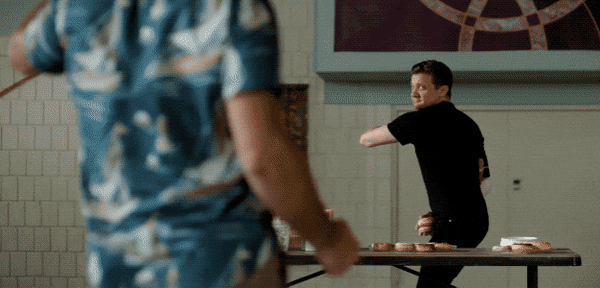 Jerry Pierce (Jeremy Renner) throws a donut at Hoagie Mallow (Ed Helms) in the movie Tag