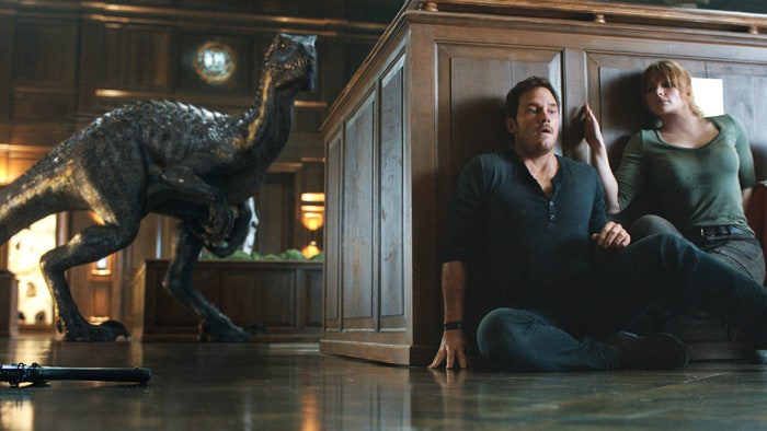 Owen (Chris Pratt) and Claire (Bryce Dallas Howard) hide from the Indoraptor in Jurassic World: Fallen Kingdom