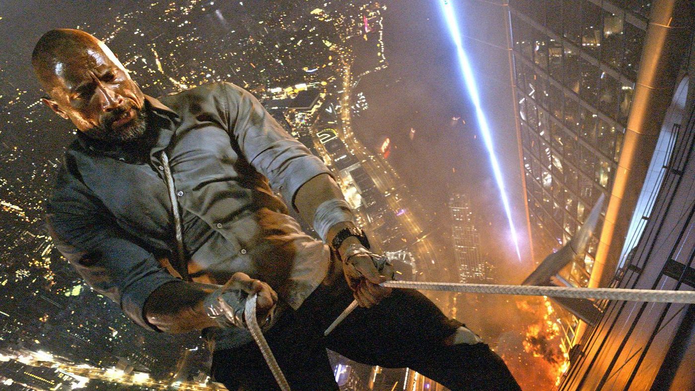 Will Sawyer (Dwayne Johnson) scales a building with the help of duct tape in the movie Skyscraper