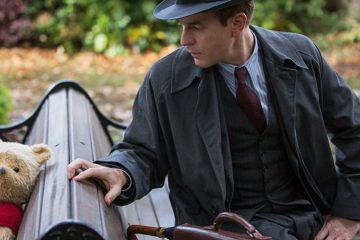 Winnie the Pooh and an adult Christopher Robin (Ewan McGregor) meet again on a park bench in Disney's Christopher Robin movie