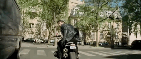 Tom Cruise as Ethan Hunt during a motorcycle stunt in Paris in Mission: Impossible - Fallout