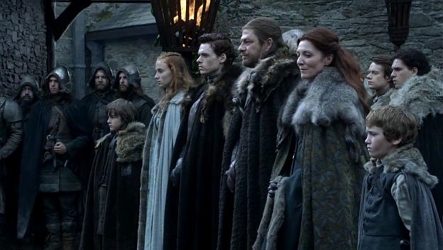Ned Stark (Sean Bean) leads his family in greeting the visiting Lannisters at Winterfell in the pilot episode of HBO's Game of Thrones