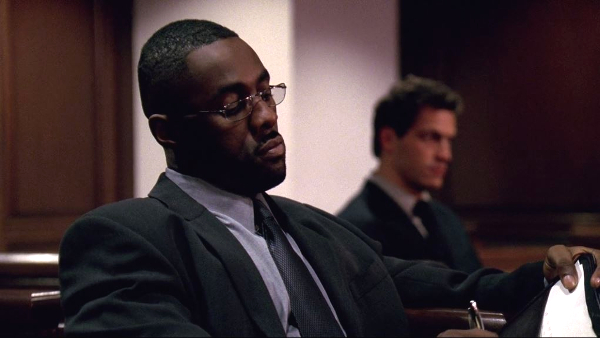 Drug kingpin Stringer Bell (Idris Elba) and detective Jimmy McNulty (Dominic West) face off in the courtroom in the pilot episode of HBO's series The Wire