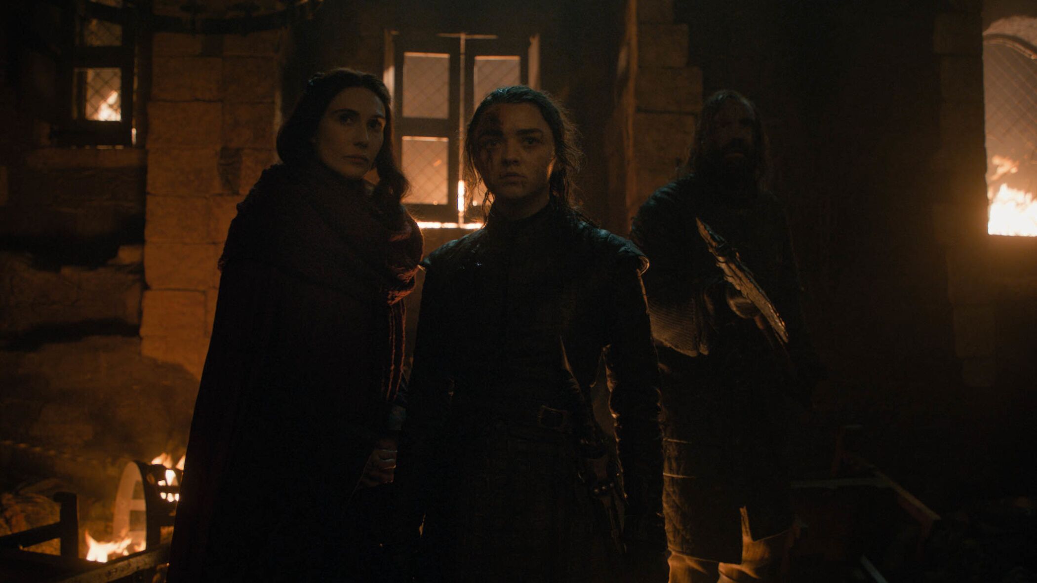 Melisandre (Carice van Houten), Arya (Maisie Williams), and the Hound (Rory McCann) hide in Winterfell during "The Long Night" on HBO's Game of Thrones