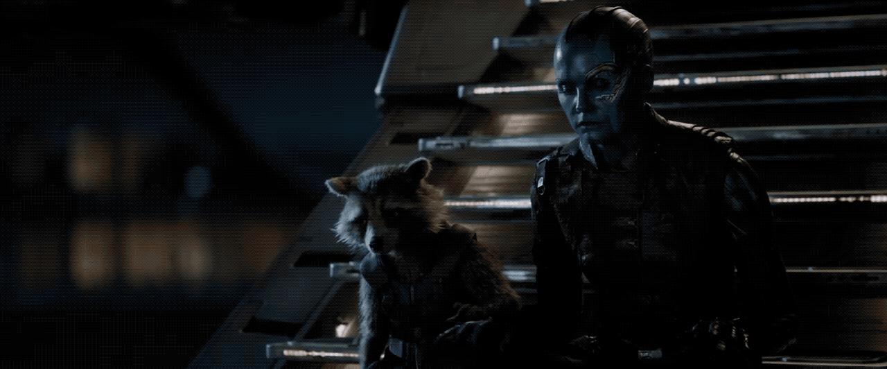 Rocket Raccoon (Bradley Cooper) and Nebula (Karen Gillan) of the Guardians of the Galaxy hold hands as they mourn in Avengers: Endgame