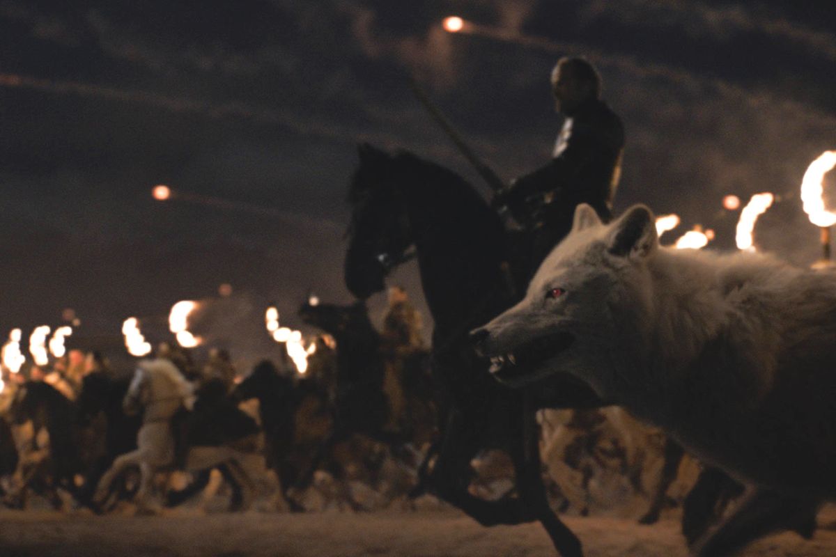 Ser Jorah Mormont (Iain Glen) and the direwolf Ghost charge alongside the Dothraki at The Battle of Winterfell in HBO's Game of Thrones episode "The Long Night"