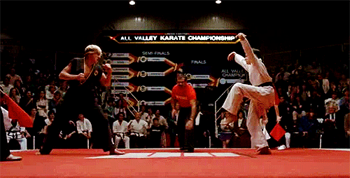 Daniel (Ralph Macchio) crane kicks Johnny (William Zabka) in The Karate Kid movie