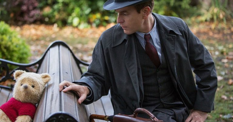 Winnie the Pooh and an adult Christopher Robin (Ewan McGregor) meet again on a park bench in Disney's Christopher Robin movie